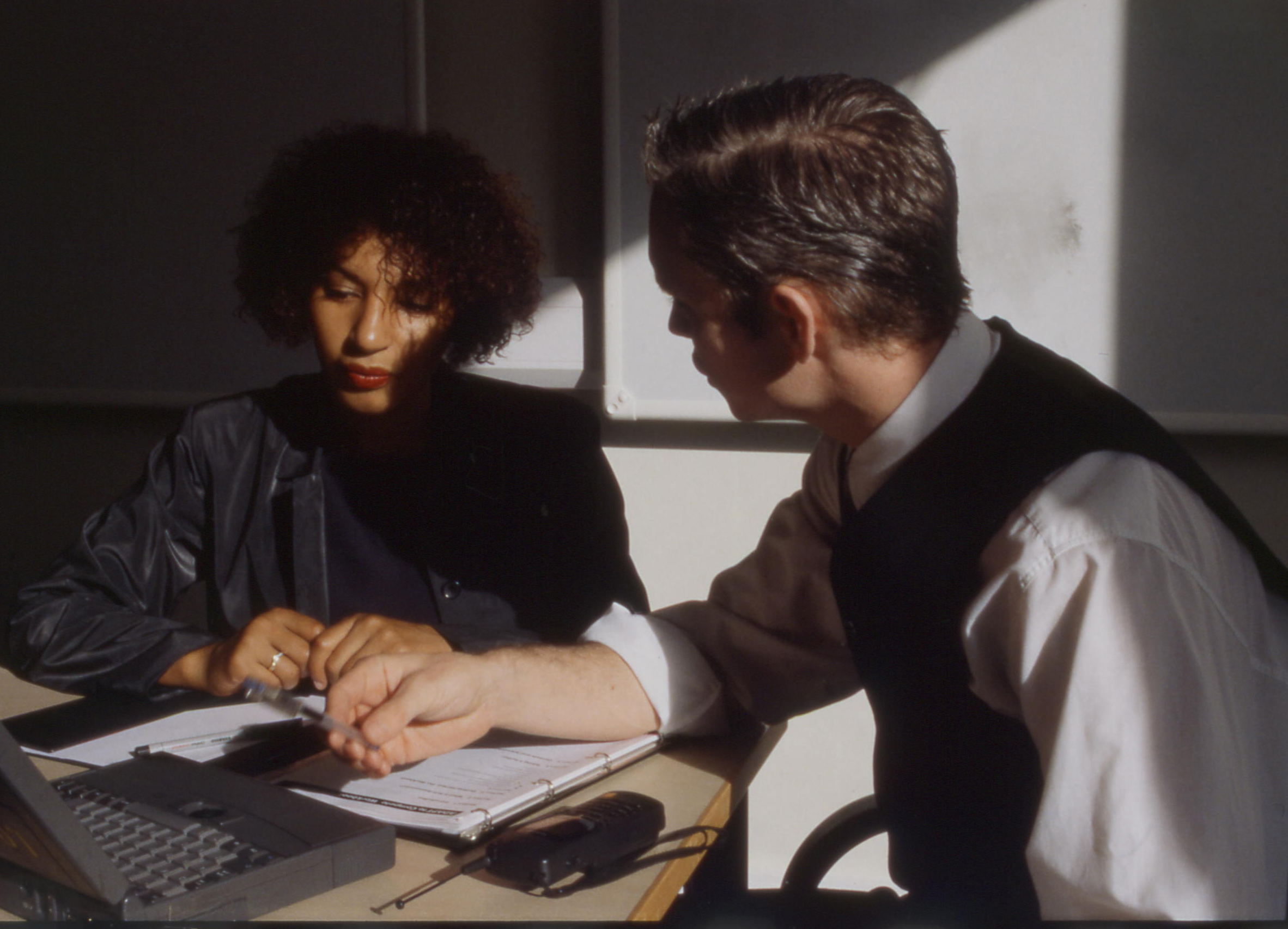 Shaded waist coat man talking to women 1 copy