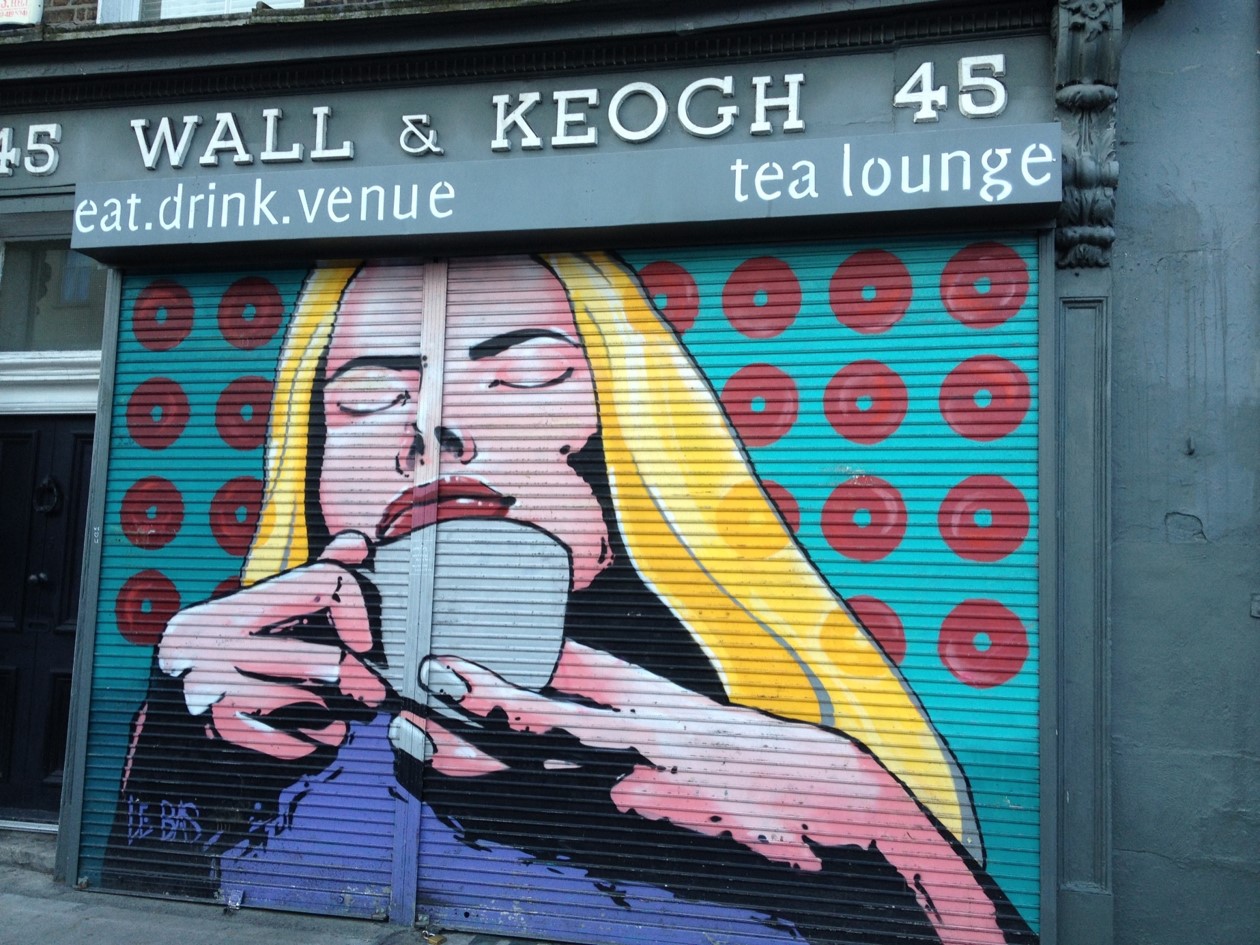 Graphic (on shutters) of lady enjoying sipping her tea with her eyes closed sipping tea 