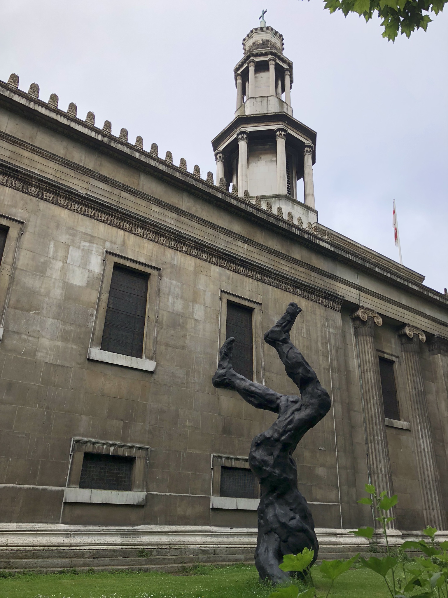Sculpture of someone burying their head in the ground